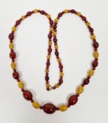 String of red amber, yellow and red stone graduated beads