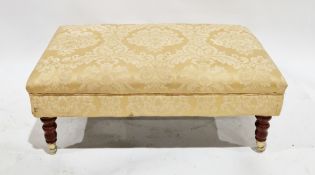 19th century style upholstered ottoman stool of rectangular form, on turned tapering baluster legs
