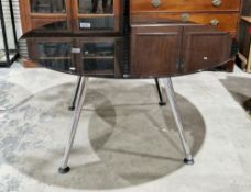 Contemporary office meeting table, of circular form with black glass top on four aluminium splayed