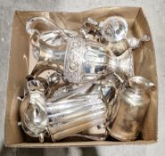 Collection of silver-plated items including a large water pitcher with embossed floral decoration,