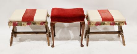 Pair of Spanish-style stools with a cream vinyl upholstered seat with tasselled fringe, on a