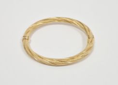 Italian 9ct yellow gold hinged bangle of textured twisted design, with safety clasp, 7.2cm wide,