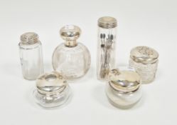 Various Victorian and Edwardian silver-topped cut-glass dressing table jars and bottles,