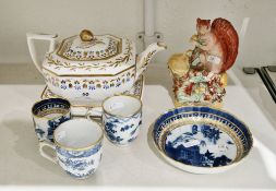 19th century Staffordshire pottery model of a squirrel beside an oak tree stump holding an acorn, on