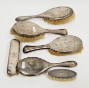 Collection of six silver backed dressing table brushes including a pair of brushes, Birmingham 1923,