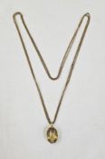 Citrine and gold-coloured metal pendant, the oval faceted stone in claw set mount, on curb link gilt