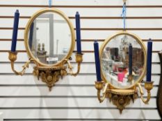 Pair of 19th century gilt framed girandole mirrors, of oval form, the demi-lune brackets each