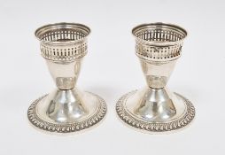 Pair of sterling silver weighted dwarf candlesticks by Duchin, each with pierced sconces, on