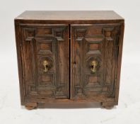 Late 19th/early 20th century Stuart Revival oak table-top cabinet, the two geometric moulded panel
