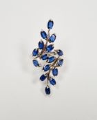 Lady's 9ct white gold dress ring set with blue stones in a naturalistic leaf and vine setting, 5.