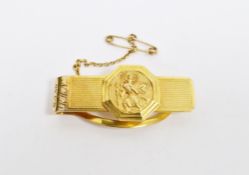 9ct gold tie clip, the engine-turned bar with octagonal St Christopher medallion, with safety chain,