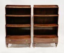Pair of mahogany waterfall bookcases in the Regency manner, of bowfronted form, cross-banded with
