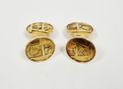 14k yellow gold pair of cufflinks, the round terminals with raised decoration including initials,