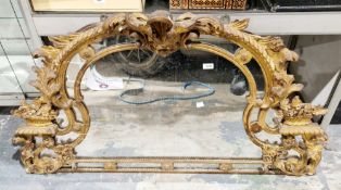 19th century giltwood and gesso overmantel mirror, of domed form, with carved scrolling foliate
