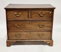 Georgian oak chest of two short over two long drawers with brass handles and escutcheons, on bracket