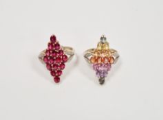 Two lady's 9ct gold lozenge shaped dress rings, one with multicoloured stones, the other red,