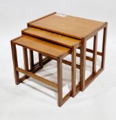 In the manner or Arne Hovmand-Olsen nest of three mid-century teak occasional tables, largest 48cm
