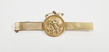 9ct gold tie clip, the engine-turned bar with circular St Christopher applied medallion, with safety