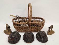 Wicker basket containing various collectables including three stoneware brown glazed wall pockets