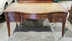 Mahogany kneehole desk in the early 19th century manner, of serpentine outline, the top with green