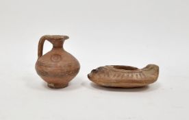 LOT WITHDRAWN Levantine terracotta oil lamp, circa AD500-700, 8.7cm long and a small terracotta jug,