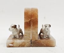 Pair of Art Deco onyx bookends, each surmounted by a cold painted spelter model of a Scottish