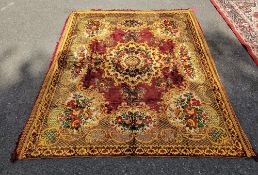 Chenille large red ground rug with central floral motif, floral spandrels, single floral border