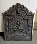 Antique cast iron fireback, the arched top cast in the form of mythical creatures, over a lion