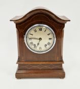 Edwardian mahogany inlaid mantel clock, the domed top over a circular dial with Roman numerals and
