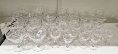20th century cut glass part table service, cut with lappets with ogee cup-shaped bowls, comprising