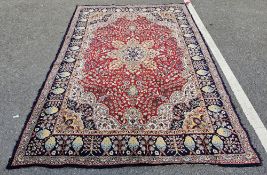 Large red ground rug with central floral medallion, floral field with hanging baskets, floral