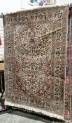 Indian Kashmir silk cream ground rug, densely decorated with stylised flowers within a border,