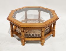 20th century octagonal coffee table with bevelled glass inset top, with a cane inset undershelf,