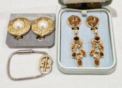 Two pairs of Christian Dior clip-on earrings, the first pair of round form with central faux pearls,