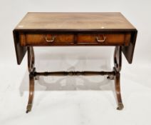 Early 20th century mahogany library table with lyre supports and lion paw feet with castors, two