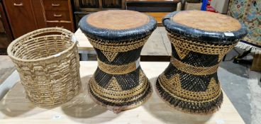 Pair of mid-century wicker drum stools of waisted form, having leather seats and pale and dark