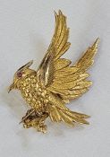 9ct gold and ruby bar brooch, the bird set with ruby eye and alighting on a branch, 5cm high x 4cm