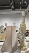 A tall marble-effect table lamp with shade