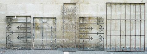 Five wrought iron fence sections of various decoration and sizes, largest 121cm x 100cm (5)