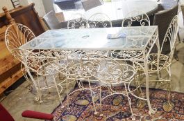 White painted wrought metal framed table with glass top and six matching chairs featuring