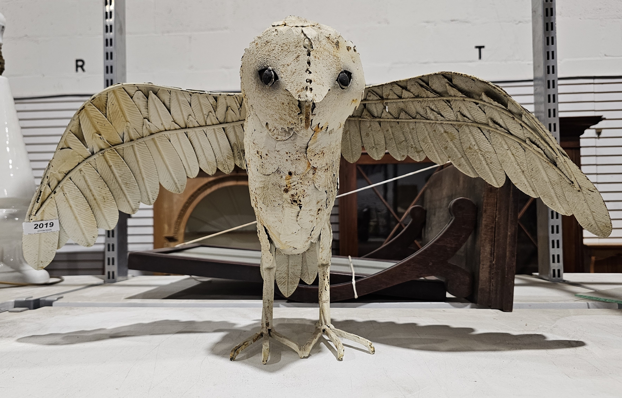 A metal sculpture of an owl Condition Report Height 33.5cm, wing span 65cm, width 29cm