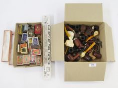 Collection of assorted tobacconalia including various pipes, including meerschaum, and carved wooden