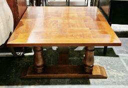 Modern hardwood coffee table of square form with parquet top, single drawer, on turned baluster legs