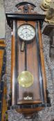 Vienna regulator-style wall clock with enamel dial in ebonised walnut case with arched pediment,