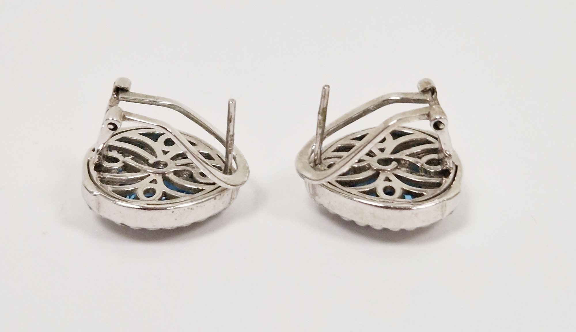 Pair of silver stud earrings set with a central teardrop blue topaz and with white sapphire details, - Image 2 of 2