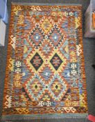 Chobi green ground kilim with two rows of three stepped lozenge medallions, multiple geometric
