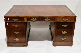 Early 20th century mahogany twin-pedestal desk, the rectangular top with brown leather inset writing