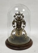 Brass skeleton clock, the open pierced dial with Roman numerals, fusee movement, housed in a glass