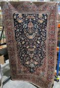 Eastern large midnight blue rug with floral field enclosin ga central urn, two floral spandrels