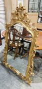 Pair of modern wall mirrors in the Rococo manner with gilt-effect foliate scrolling frames, 142cm
